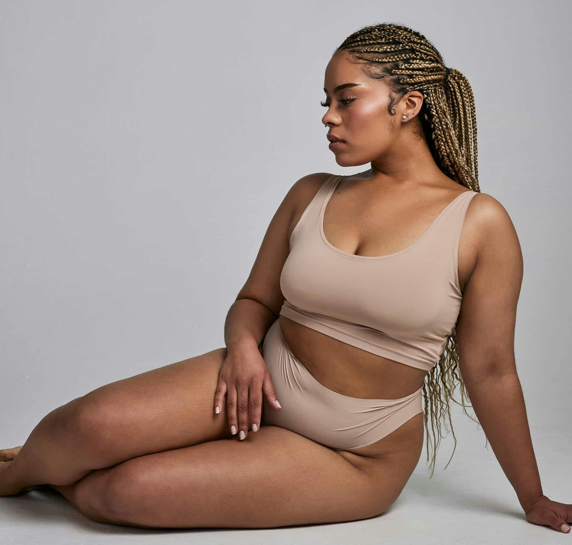 Woman sitting on floor posing