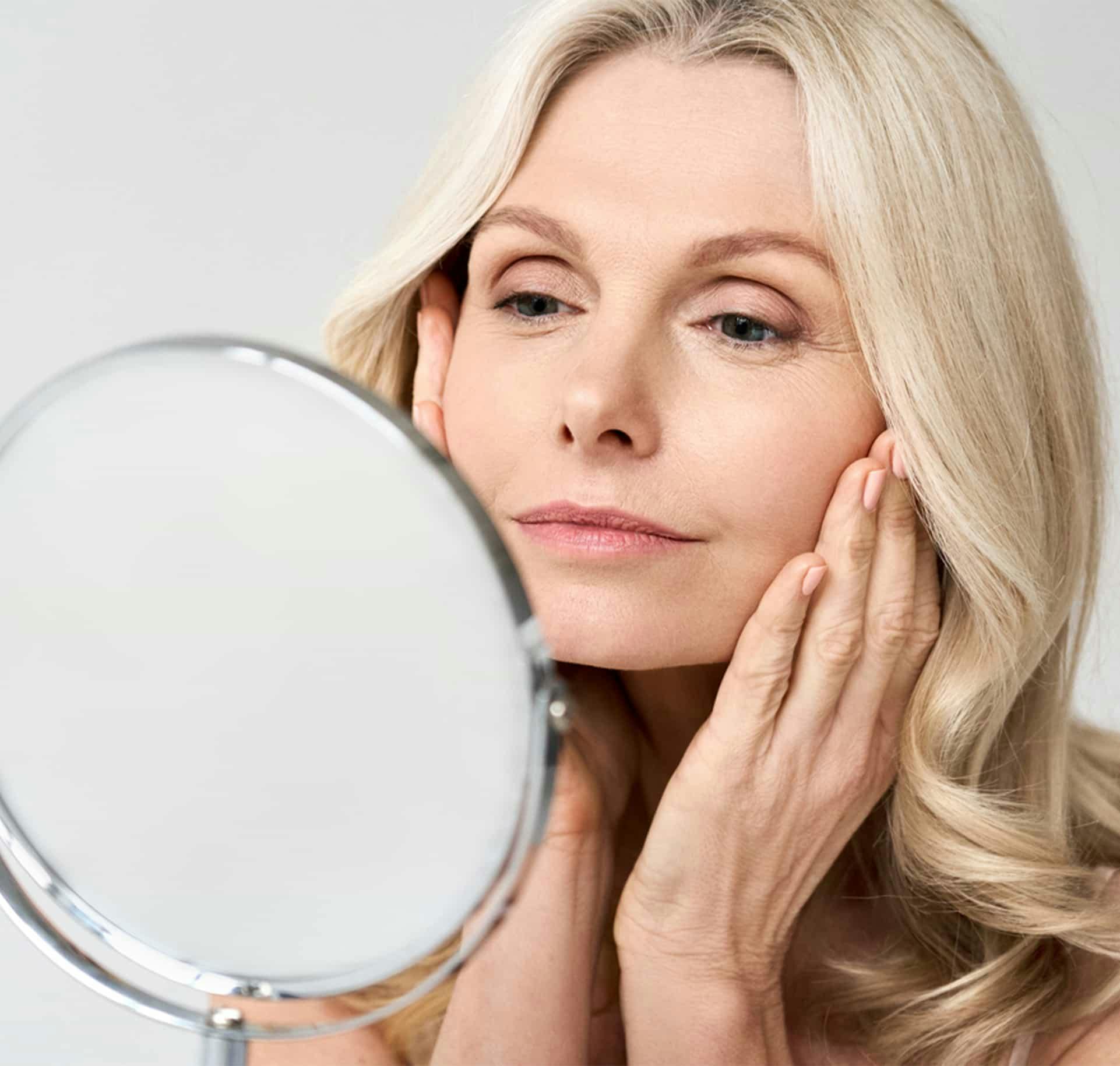 Older woman looking at mirror