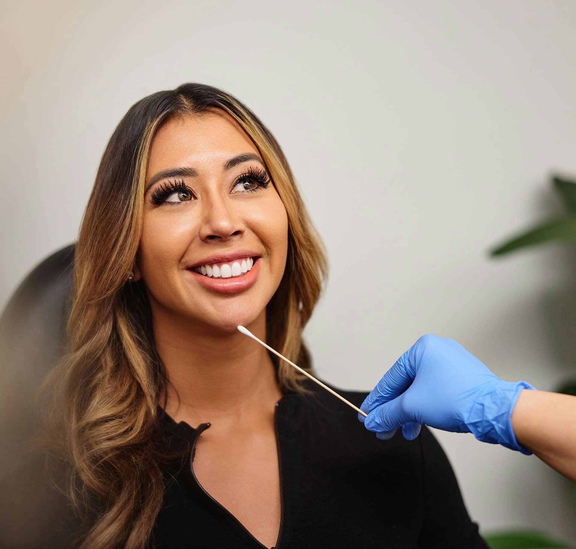 Woman touching face smiling