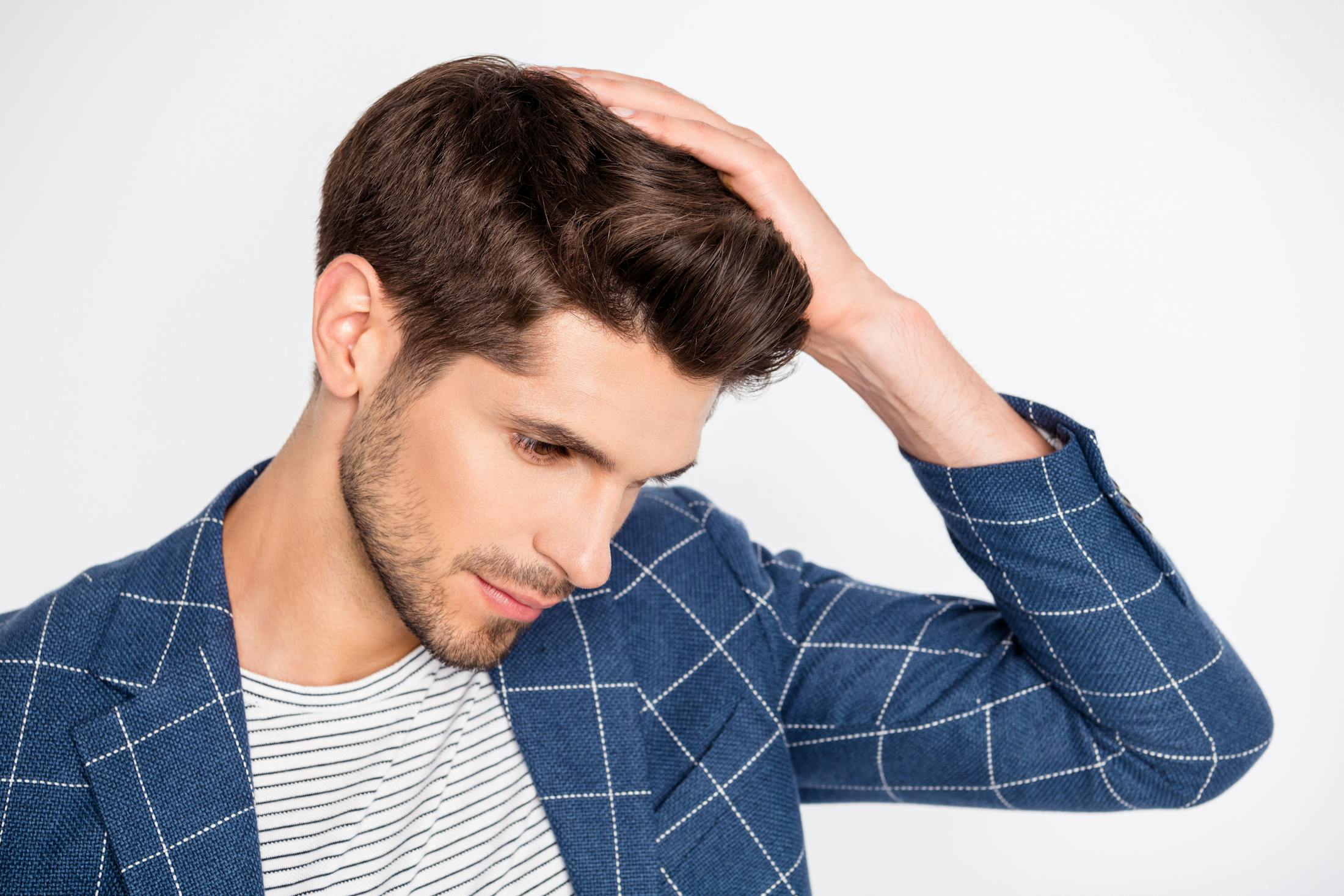 man touching hair on head