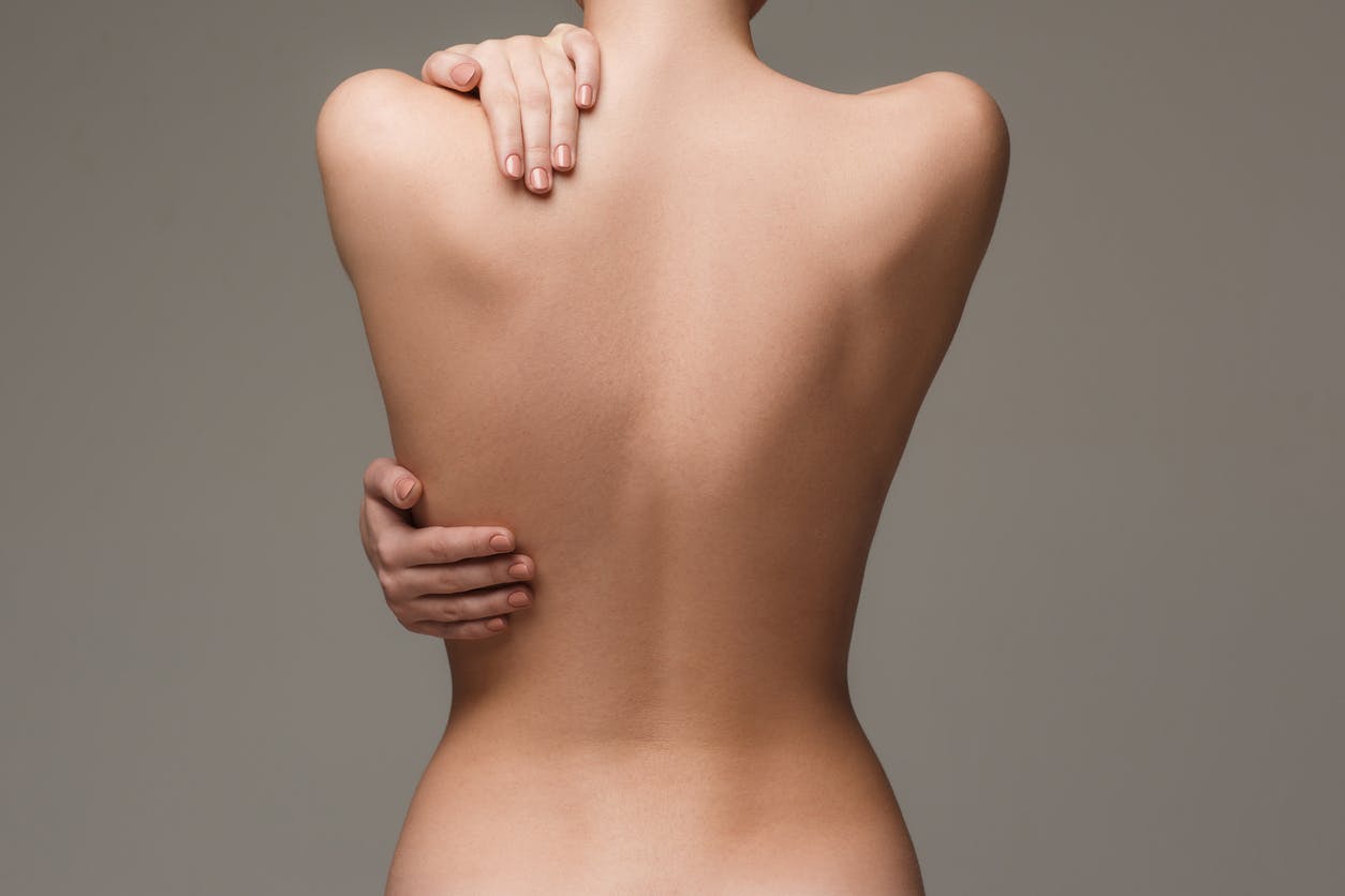 Woman touching her back