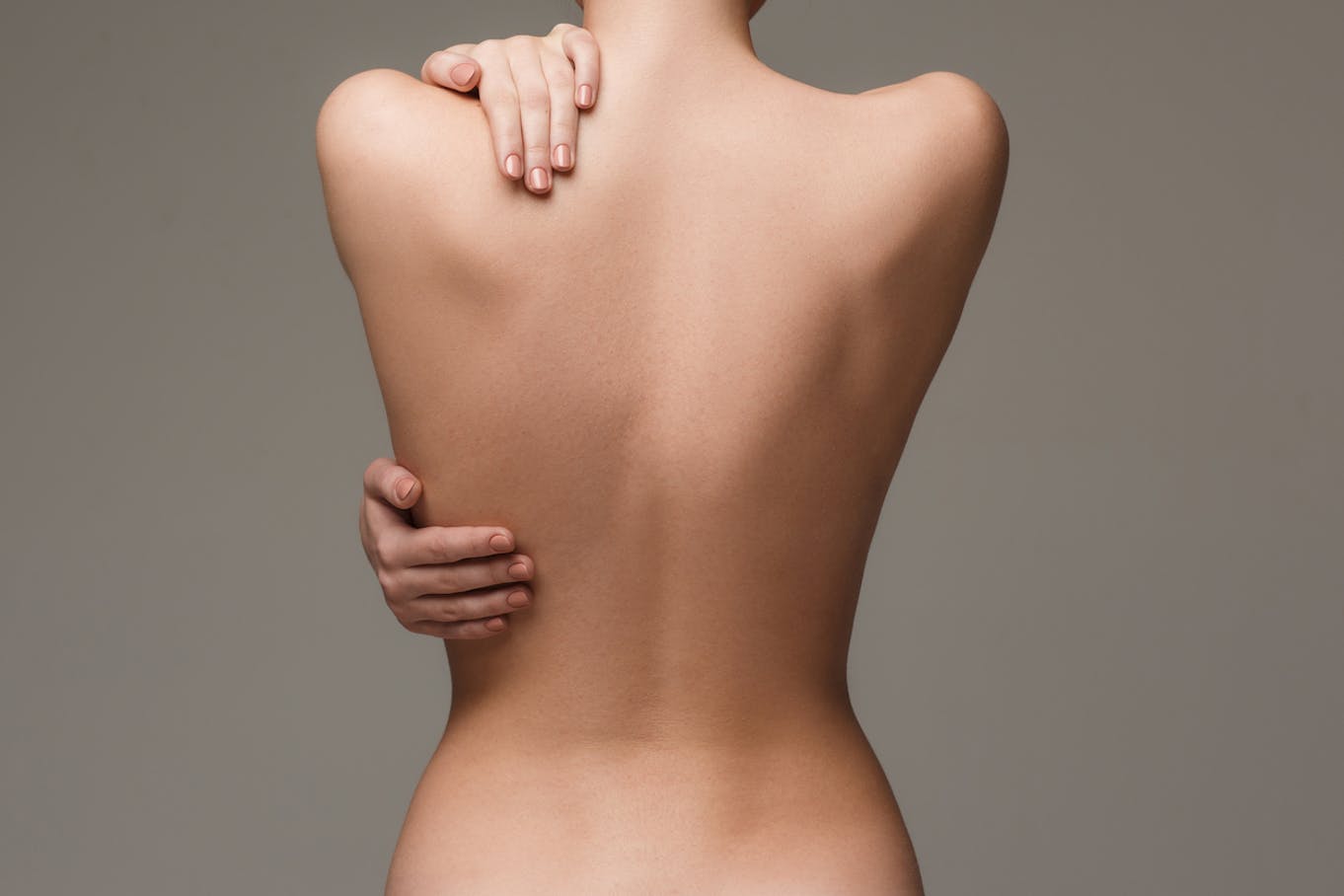 Woman touching her back