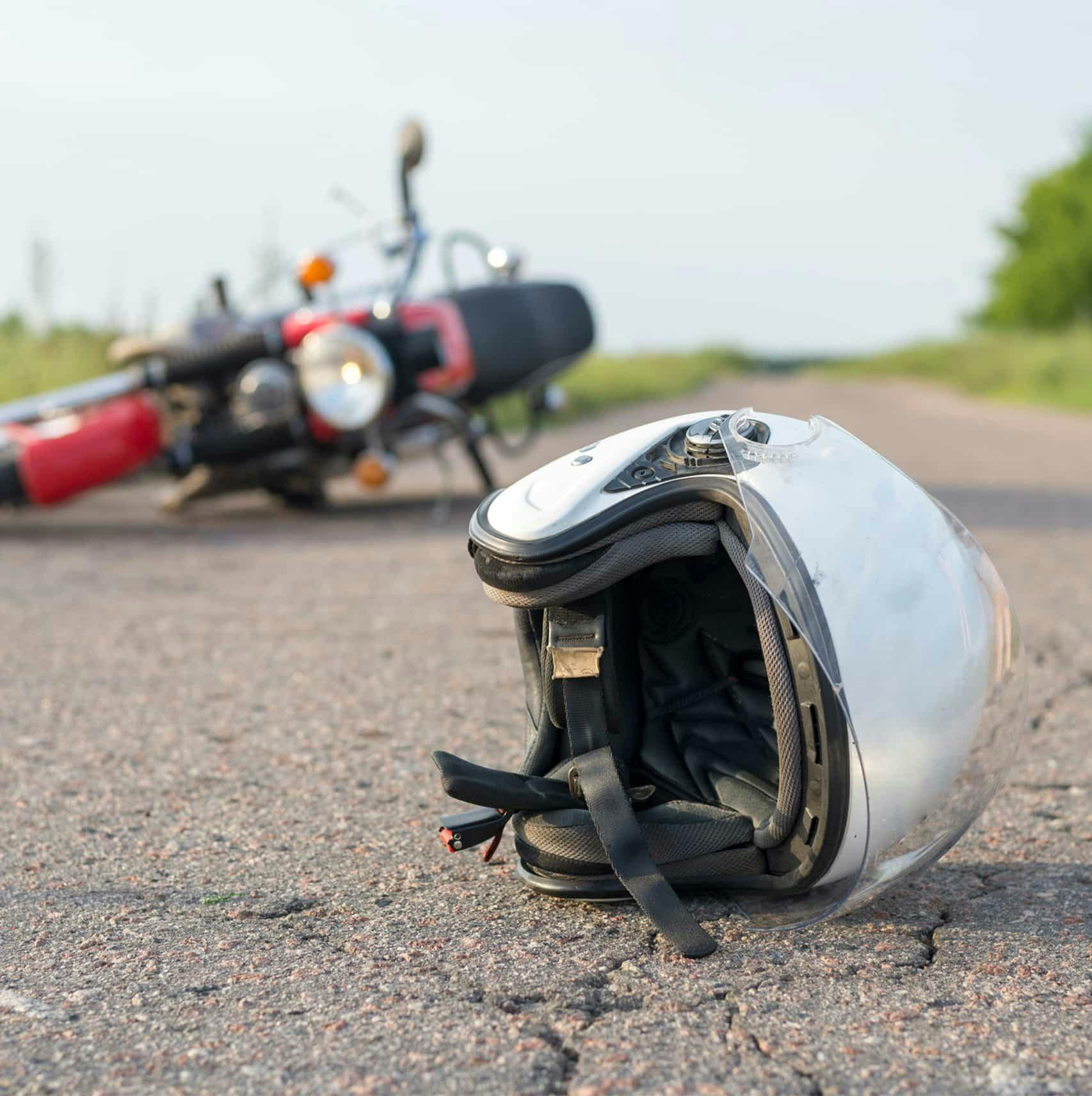 Helmet on the ground next to a downed motorcycle