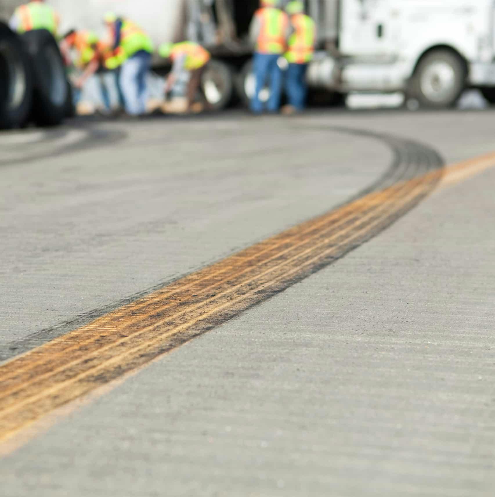 Tire skidmarks on the road leading to the site of a truck crash