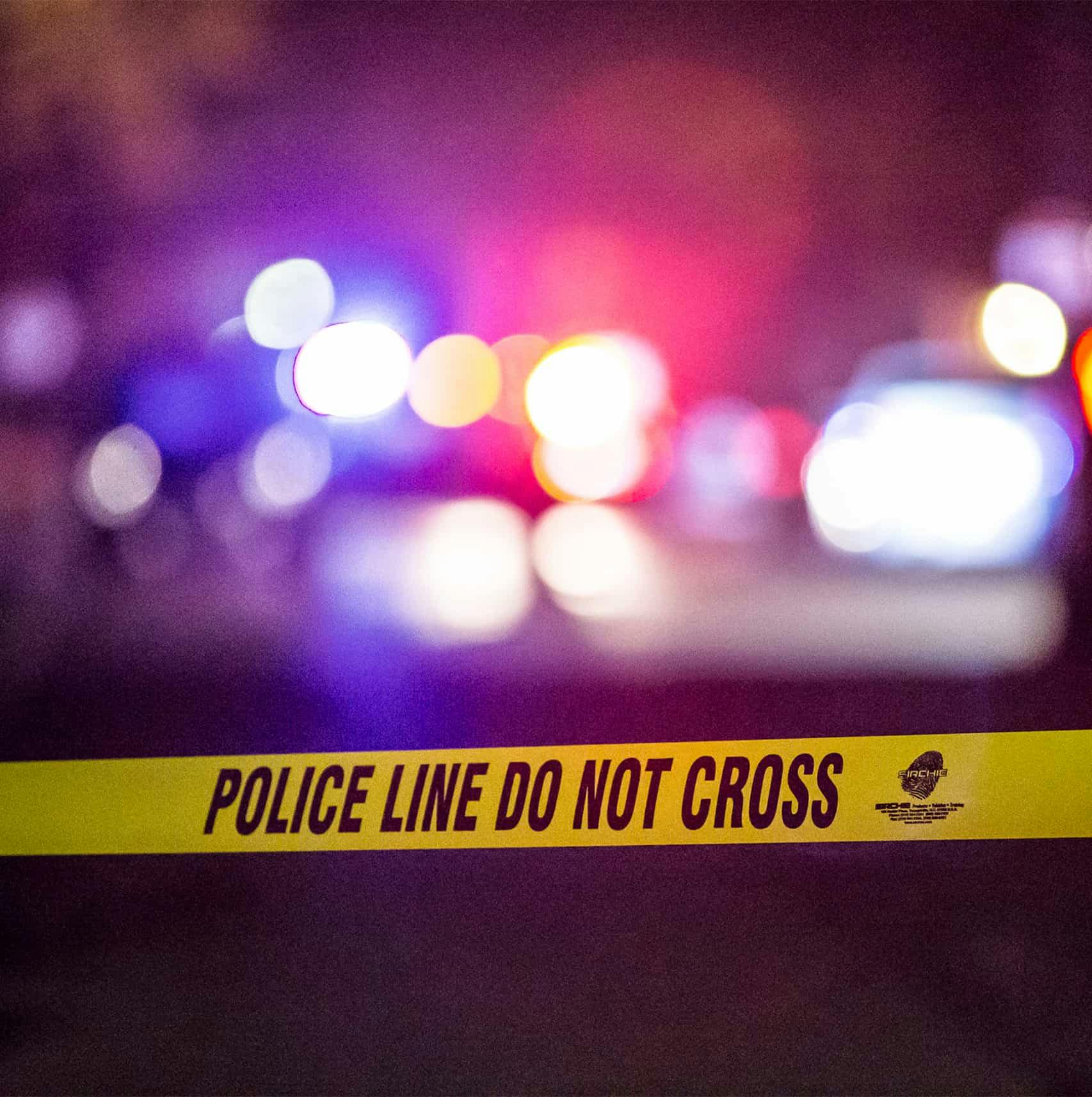 Police caution tape in front of a bad car accident