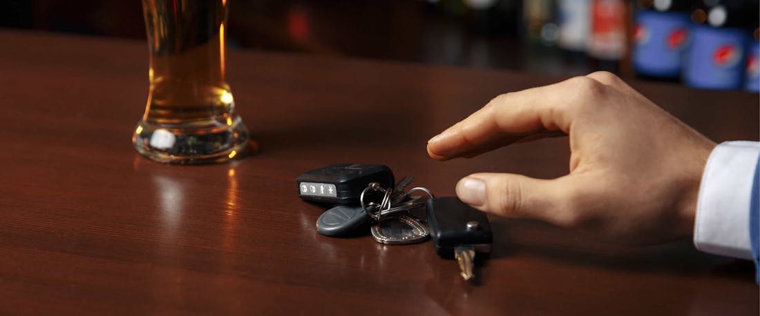 A man in a bar reaching for car keys