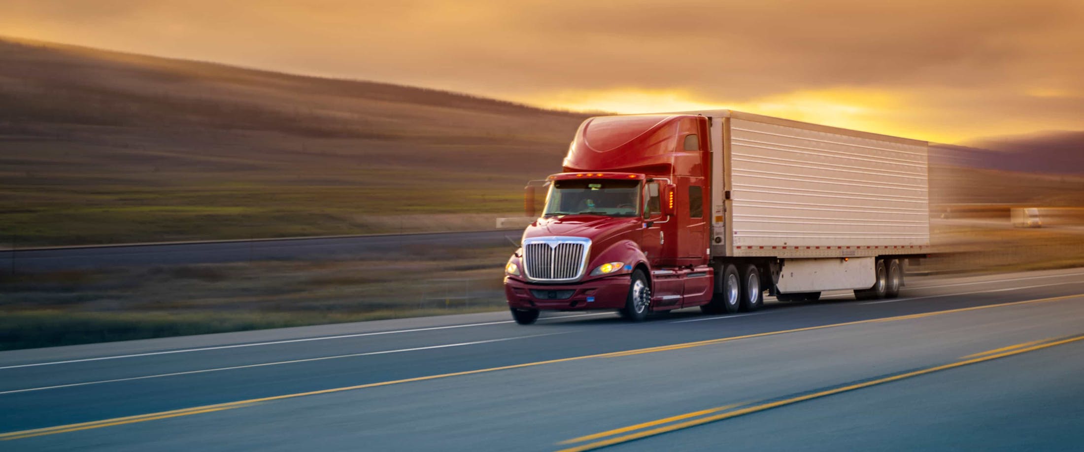 An 18-wheeler truck driving down the interstate