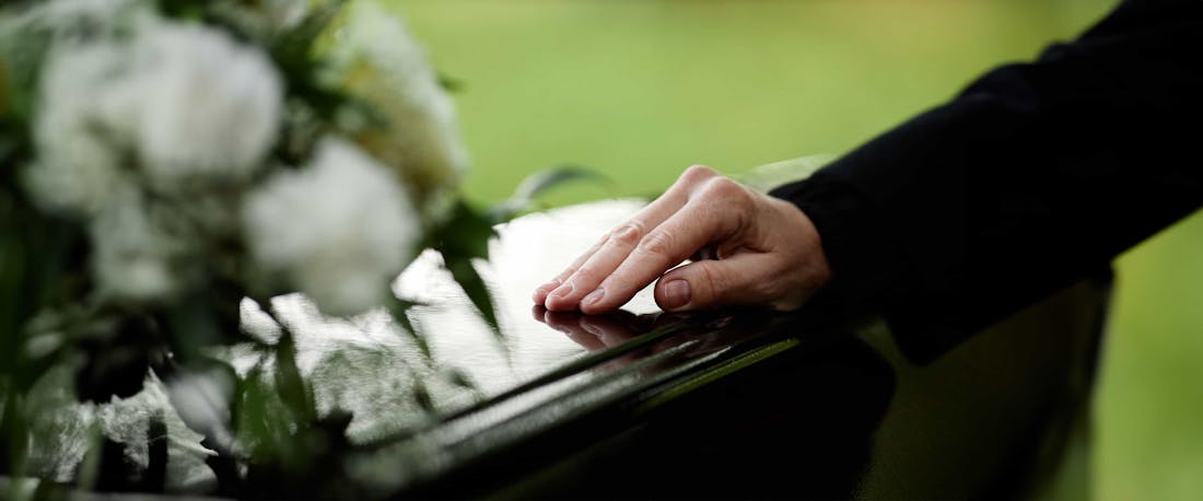 A hand on a casket