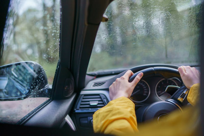 Woman driving a car in bad weather