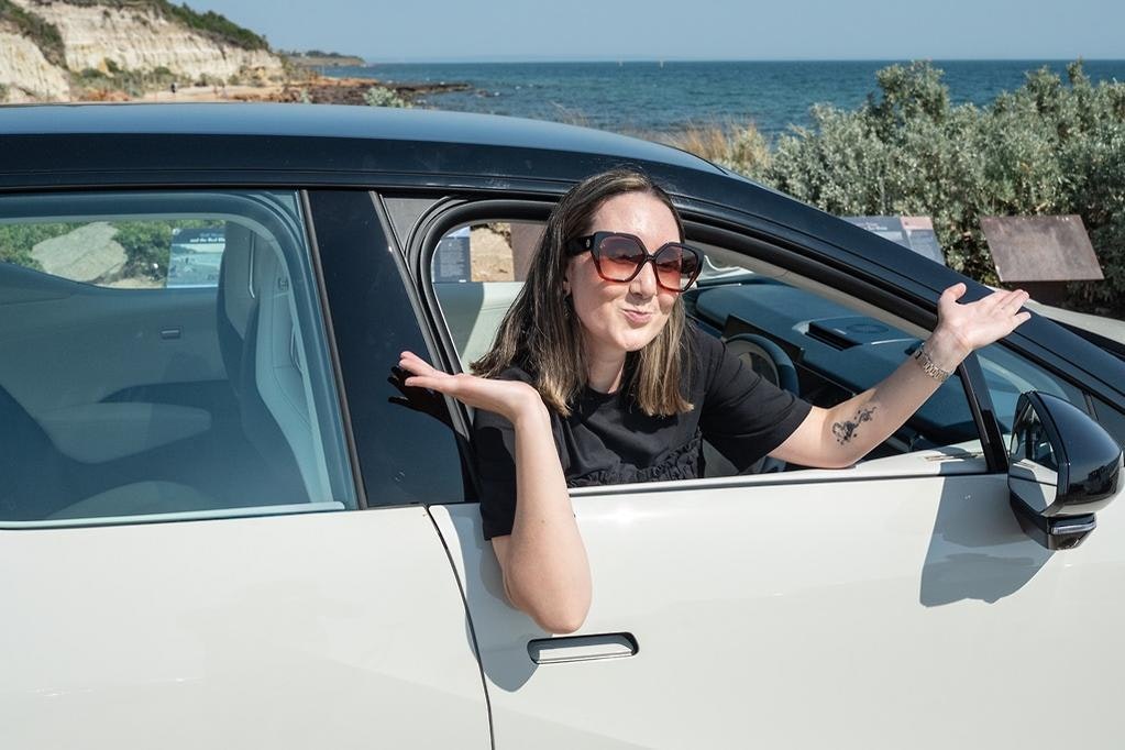 ZEEKR X Luxury Electric SUV in Palace Beige with Andrea Hobbs smiling out the window.