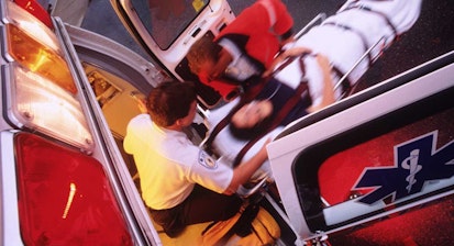 An EMT moves woman on gurney into an ambulance. Missouri
