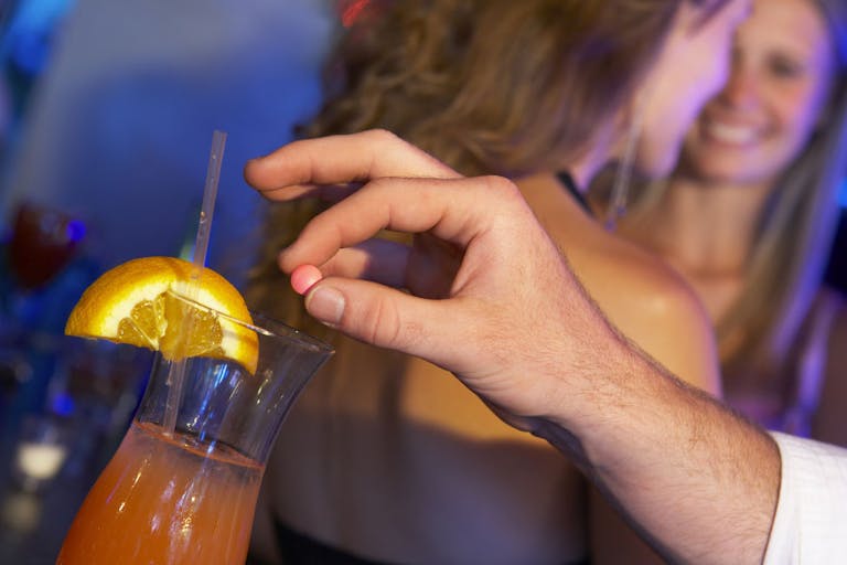 Man Drugging Woman’s Drink In Bar