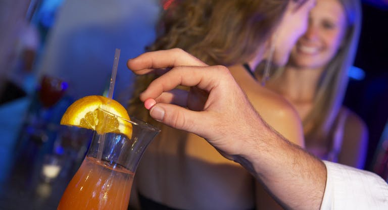 Man Drugging Woman’s Drink In Bar