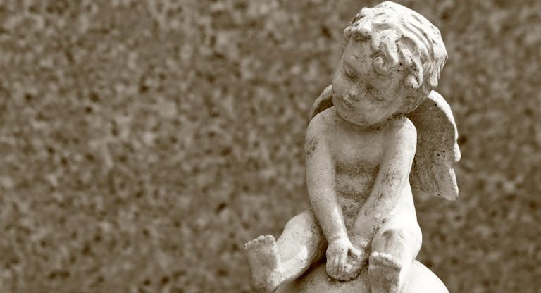little angel statue and space for text