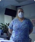 Nurse in hospital room with mask on