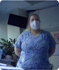 Nurse in hospital room with mask on