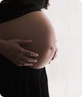 A woman holding her pregnant belly
