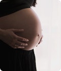 A woman holding her pregnant belly
