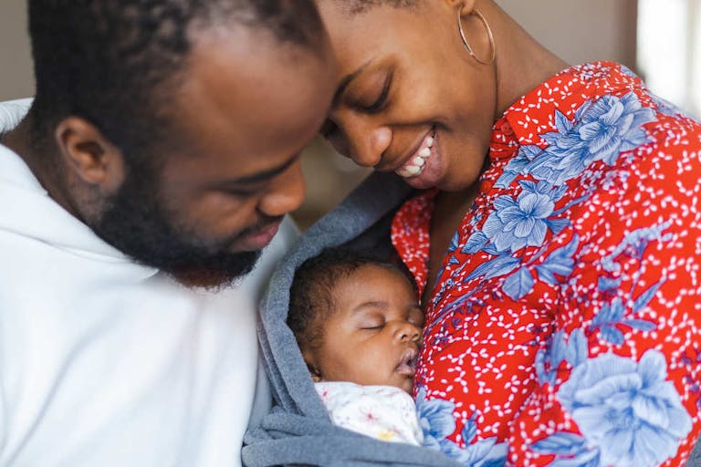 Young parents with their baby girl at home
