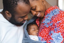 Young parents with their baby girl at home