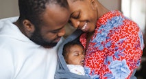 Young parents with their baby girl at home