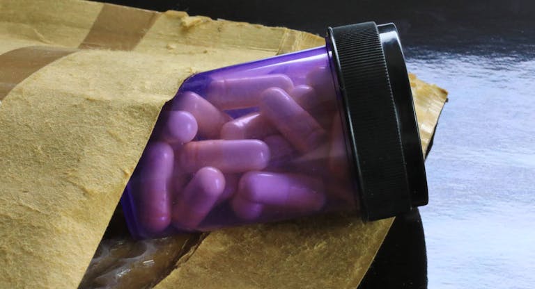 Prescription medicine bottle in a international shipping package