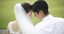 Bride and groom touching foreheads