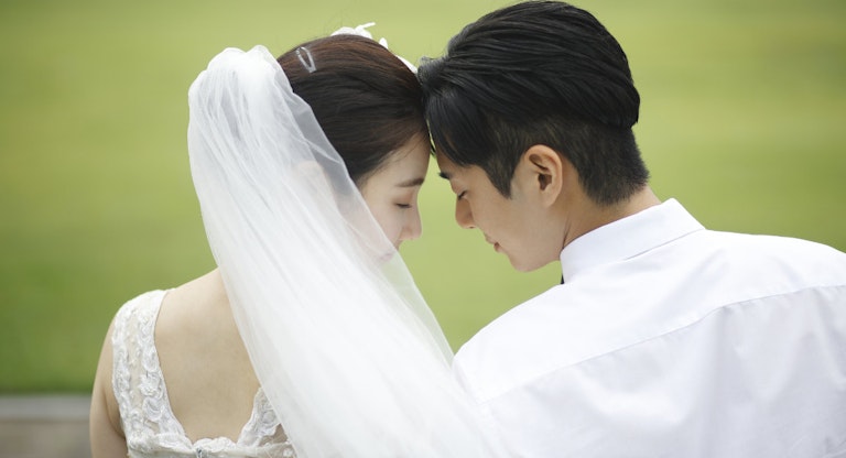 Bride and groom touching foreheads