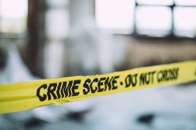 Crime scene tape against a blurred background