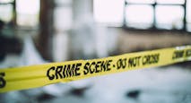 Crime scene tape against a blurred background