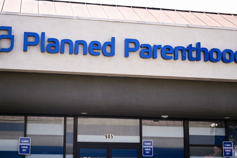 Photo by PATRICK T. FALLON/AFP via Getty Images Planned Parenthood sign, California