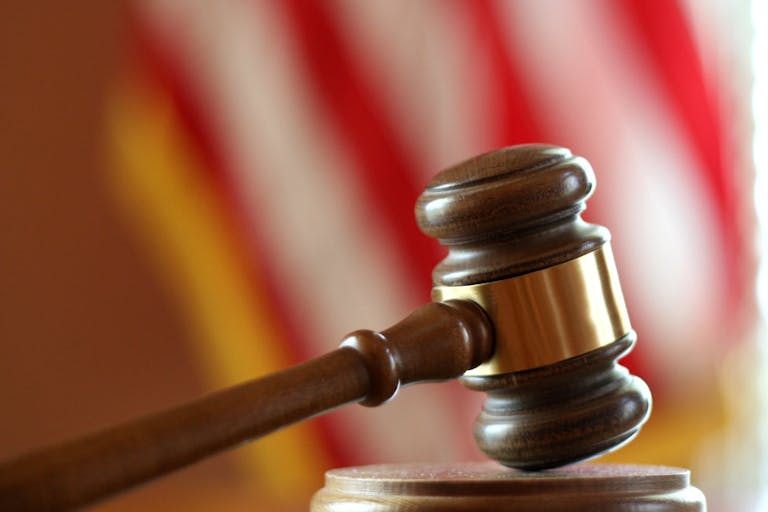Photo: ftwitty/Getty Images Gavel with American flag in background