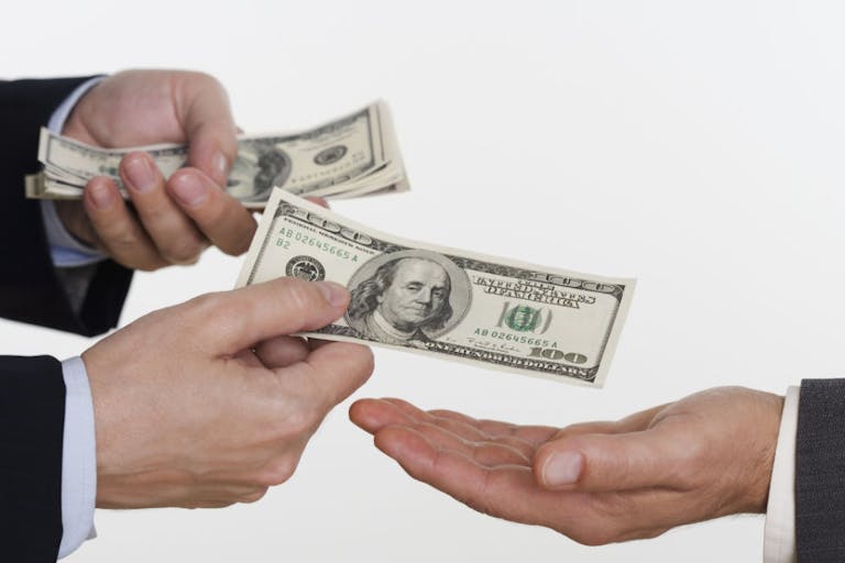 Businessman giving money to a man Did abortion pill manufacturer’s paid ‘consultants’ disclose conflicts of interest? featured image