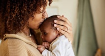 Mother kissing with her baby boy in her arms