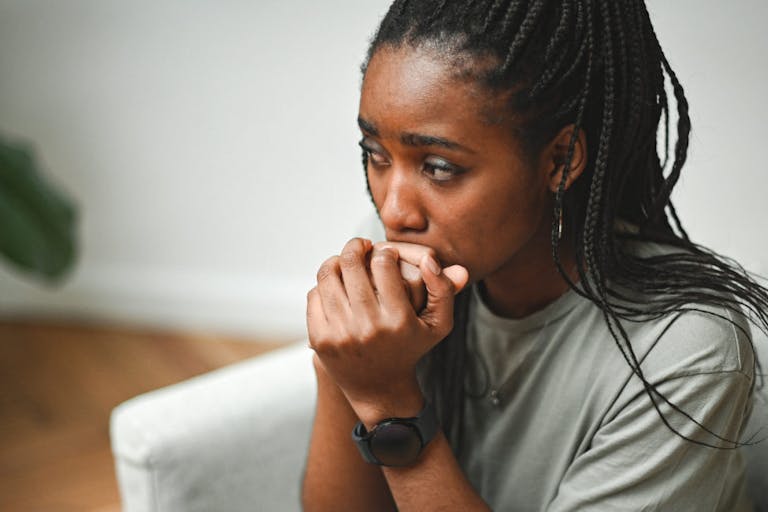 young woman sitting on the floor in sadness