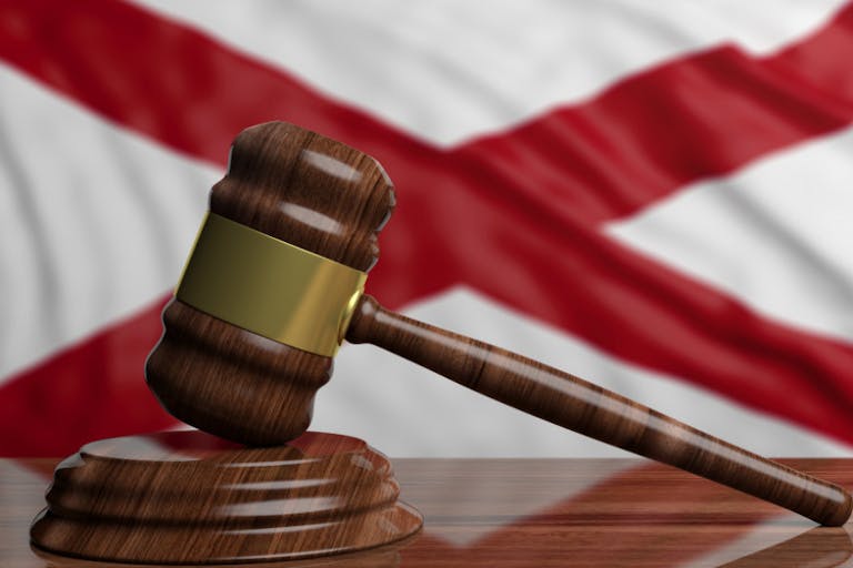 Judge or auction gavel on Alabama US America flag background. 3d illustration