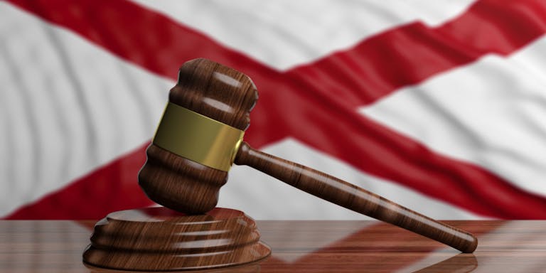 Judge or auction gavel on Alabama US America flag background. 3d illustration