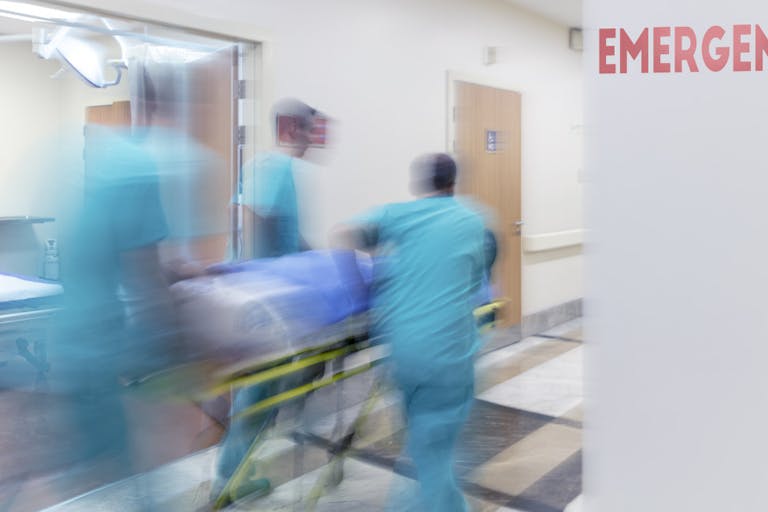 Doctor wheeling patient