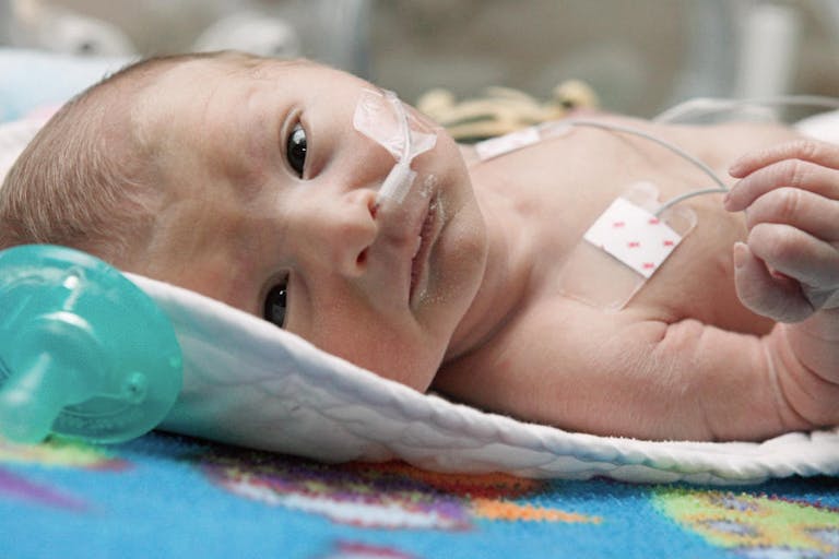 Newborn baby in incubator