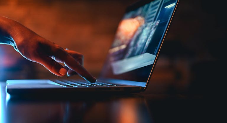 hand typing on computer keyboard
