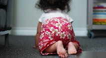 Baby girl crawling on floor