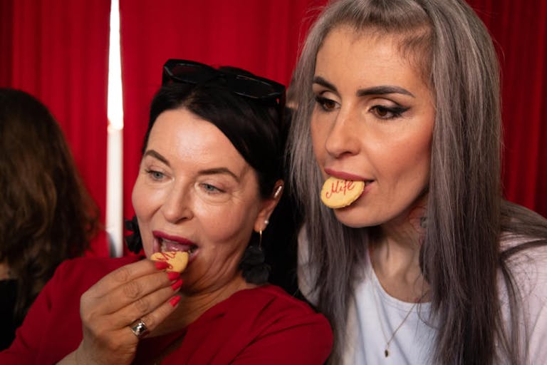 Women are seen eating cookies with the names of abortion Activist group opens abortion pill center across from Poland’s parliament featured image