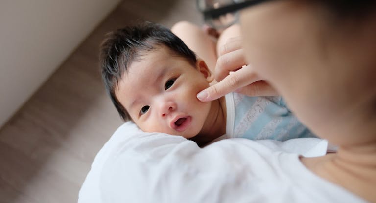 Asian mother comforting  baby