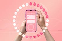 Menstrual cycle tracker mobile app on the smartphone screen in the hands of a woman. Modern technologies for tracking women’s health, pregnancy planning