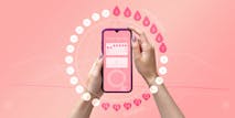 Menstrual cycle tracker mobile app on the smartphone screen in the hands of a woman. Modern technologies for tracking women’s health, pregnancy planning