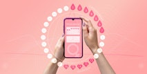 Menstrual cycle tracker mobile app on the smartphone screen in the hands of a woman. Modern technologies for tracking women’s health, pregnancy planning