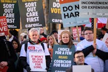 Photo: Leon Neal/Getty Images LONDON, ENGLAND - NOVEMBER 29: Supporters of the "Not Dead Yet" campaign, which opposes the Assisted Dying Bill, react outside the Houses of Parliament as news breaks that the Bill has passed the first stage, on November 29, 2024 in London, England. Today Members of Parliament are debating and voting on the second reading of the Terminally Ill Adults (End of Life) Bill, also referred to as the Assisted Dying Bill, which would give adults in England and Wales the right to choose to end their lives. The landmark private member's bill, proposed by backbench Labour MP Kim Leadbeater, would allow terminally ill people - who meet a set of safeguarding criteria - to seek medical assistance to die at a time of their choosing. (Photo by Leon Neal/Getty Images)