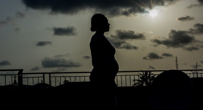 Silhouette Pregnant Woman Standing Against Sky During Sunset