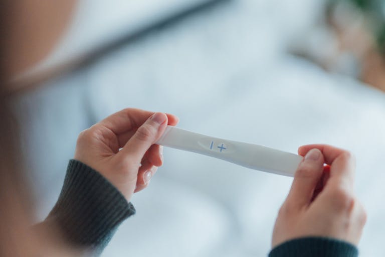 Rear View Cropped Shot Of Unrecognisable Woman Taking Pregnancy Test At Home