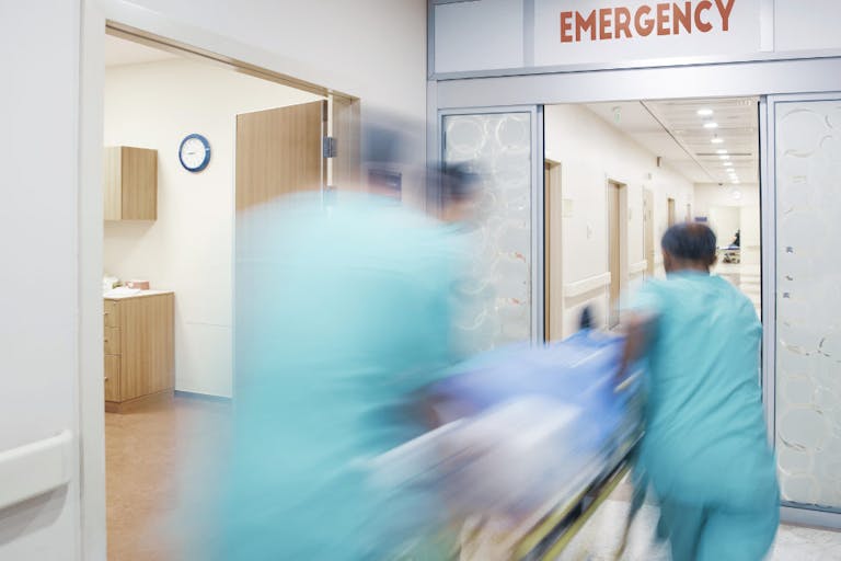 Doctor wheeling patient